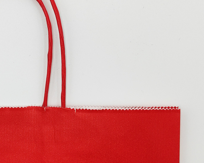 Shopper rosso in carta kraft con maniglia ritorta